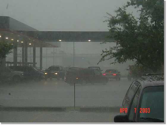 cars hide under service station awning